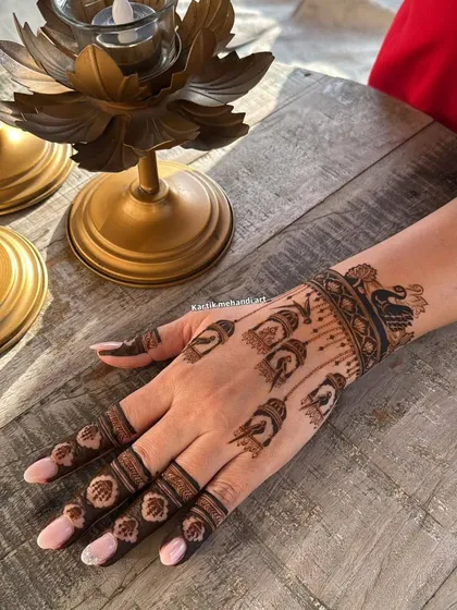 The back of the hand for the bird cage design, featuring hanging cages and a peacock wristband, creating a cohesive and unique theme.