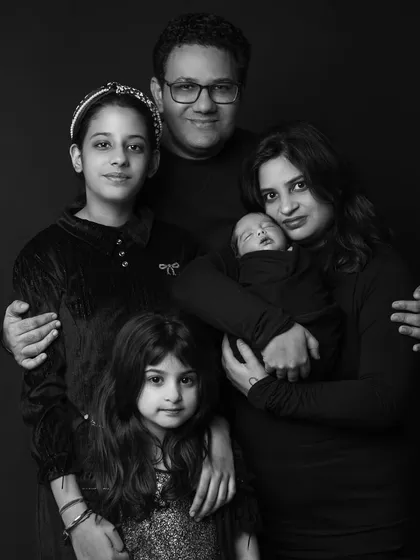 This classic black and white portrait captures a beautiful family of five welcoming their newest member. I work to make everyone feel comfortable, from the oldest sibling to the sleeping newborn, creating a timeless image that shows the unique bond your family shares.
