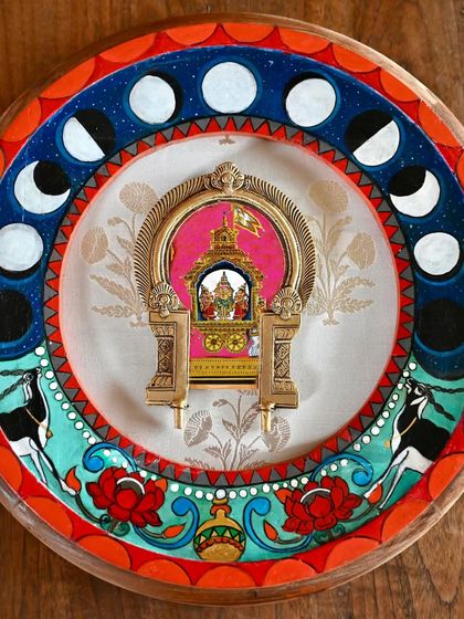 A full view of the hand-painted Chandra frame. The artwork features antelopes, Chandra's celestial mount, and the phases of the moon, all encircling a vintage Prabhavali. The piece is born from the story of the Samudra Manthan, or the churning of the milky ocean.