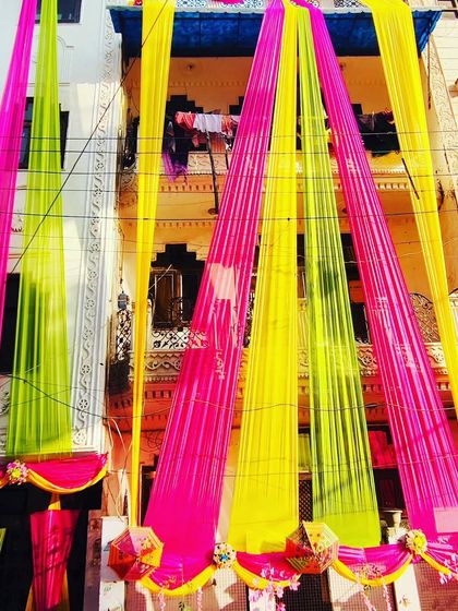 Another perspective of the colourful house draping, highlighting the festive look against the sky.