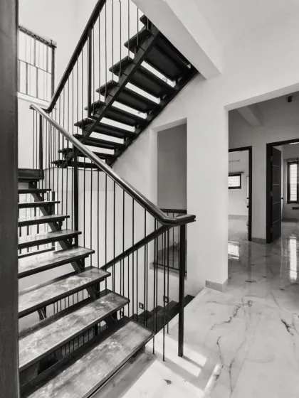 A staircase is more than just a way to get from one floor to another; it can be the sculptural soul of a home. We designed this floating metal staircase to be a light-filled, focal element. Its clean lines and strong form add a modern, industrial character to the space.