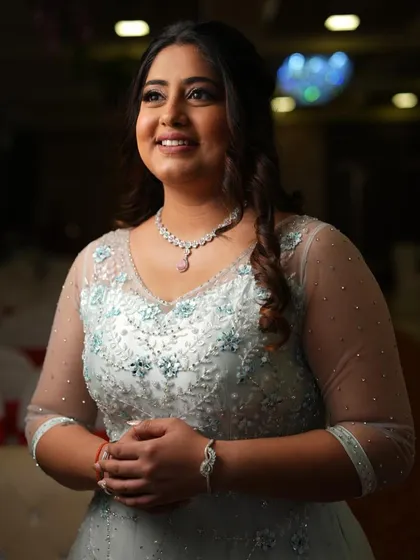 A classic portrait from her engagement. The soft lighting highlights the subtle shimmer in her makeup and the intricate details of her gown.