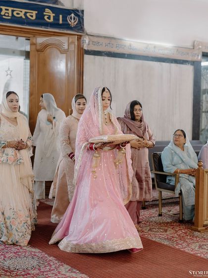 The bride's serene entrance into the Gurudwara for her Anand Karaj ceremony.