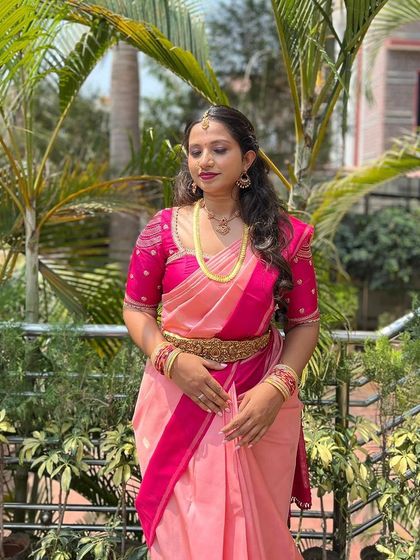 A full-length view of the pink ombre saree ensemble, a soft and feminine choice for an engagement or pre-wedding event.
