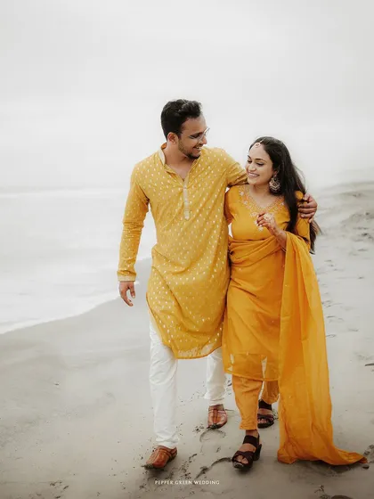 A relaxed walk along the shoreline, this image captures the serene and happy atmosphere of their beach pre-wedding shoot.