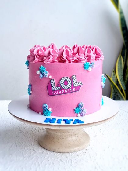 A full view of the pink LOL Surprise buttercream cake.