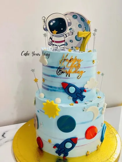 A celestial two-tier space cake, perfect for a 7th birthday blast-off into a new year.