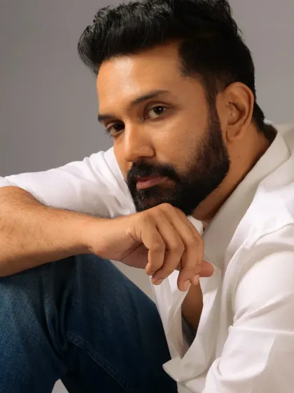 "Keeping it casual." This close-up shows the detail in the beard grooming and the subtle makeup work that creates a flawless yet natural look.