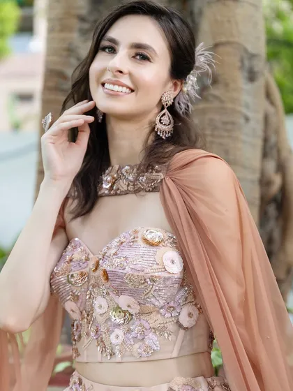 The flowing cape and soft hair add a touch of modern romance to this elegant morning look.