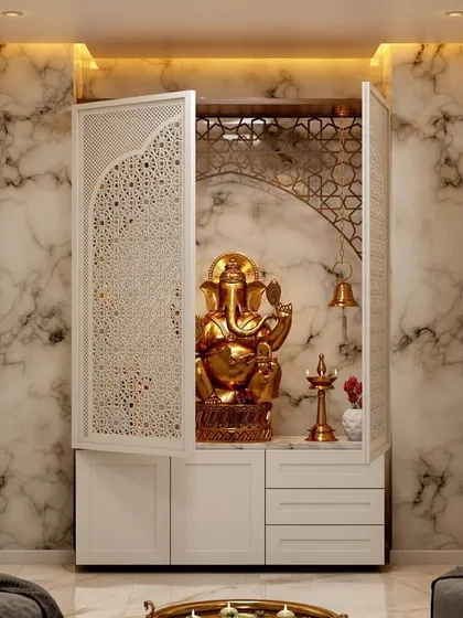 A dedicated pooja space can be both beautiful and compact. This custom cabinet unit features intricate jaali work, built-in storage, and elegant lighting, creating a peaceful corner for prayer within a modern home.