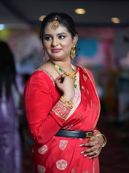 A three-quarter portrait capturing her elegant pose and the details of her makeup and jewelry.