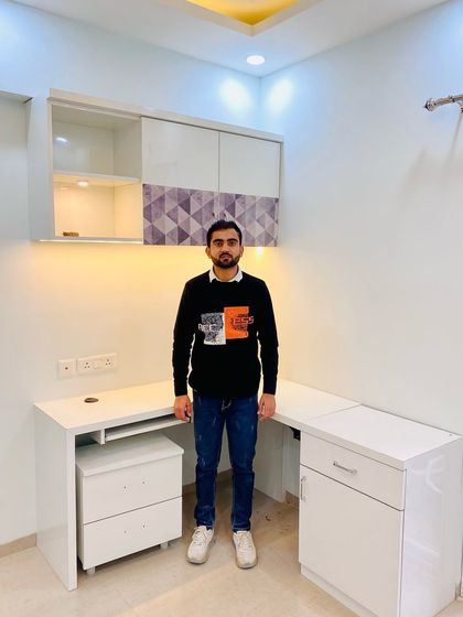 Presenting a completed L-shaped study table with overhead storage, designed to fit perfectly in a corner and maximize workspace.