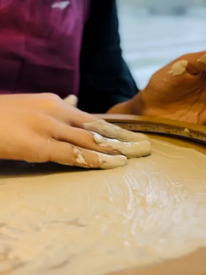 The beauty is in the details. A close-up shot of hands shaping the craters on a moon lamp, showing the tactile nature of this art form.