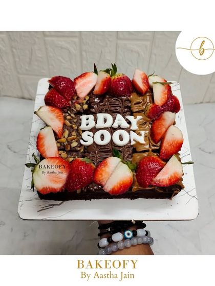 A beautiful brownie slab decorated with Nutella drizzle, fresh strawberries, and walnuts. This is a perfect treat for a birthday or any celebration, combining rich chocolate with fresh fruit.