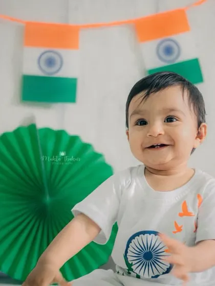 A beautiful, bright smile from a milestone session celebrating Independence Day. I love creating these festive setups with colorful props that bring out the happiest expressions from your child.