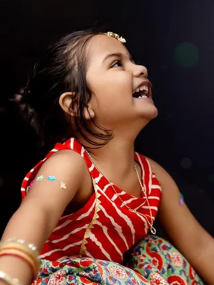 Looking up at the lights with wonder. This Diwali portrait captures the magic and joy of the festival through a child's eyes.