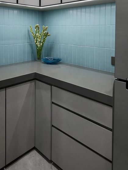 Even the office pantry deserves thoughtful design. We used calming blue vertical tiles and sleek grey cabinetry to create a clean, modern, and refreshing break area for employees.