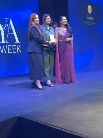 On stage at Seeya Fashion Week, accepting an award with my team. It's a proud moment that recognizes all the hard work and creativity that goes into styling a show.