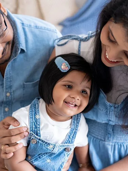 A close-up of a happy family, their faces close together, sharing a smile.