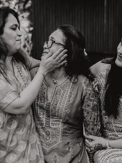 A beautiful, candid moment of affection between three generations of women. A tribute to the strength and love of mothers.