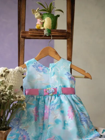 A sweet blue floral dress with a pink sash. This piece is hanging in my studio, ready to find a home with a little girl who loves color and flowers.