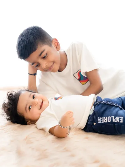 A candid moment where an older brother looks lovingly at his baby brother. These unposed shots are perfect for capturing the real emotions of childhood.