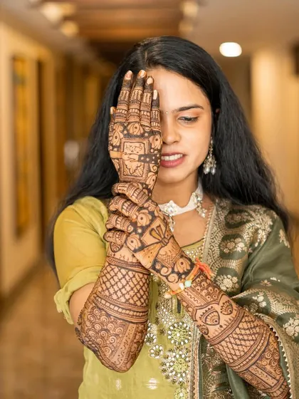 A candid shot of the bride admiring her full bridal mehendi. These are the moments I cherish as an artist.