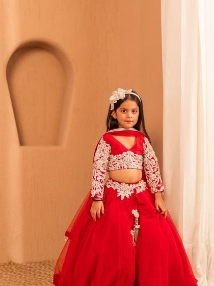The sweetheart neckline and full sleeves with detailed embroidery make this red lehenga a unique and festive choice.