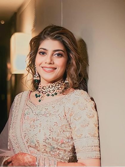 A stunning portrait of the bride, her smile as radiant as her Mehendi outfit.