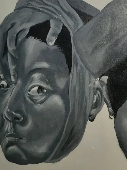 Another detail shot, this time showing the interaction between the hand and the face, creating a dynamic and slightly unsettling feeling.