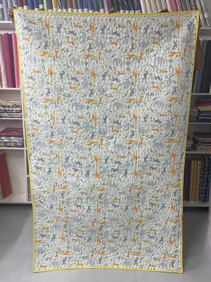 The back of the elephant quilt, featuring a playful animal-print fabric.