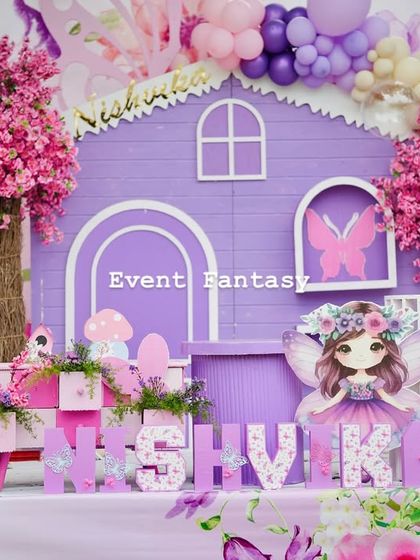 A close-up of the purple fairy house from Nishvika's party, showing the beautiful details like the pink cherry blossom trees and flower boxes.