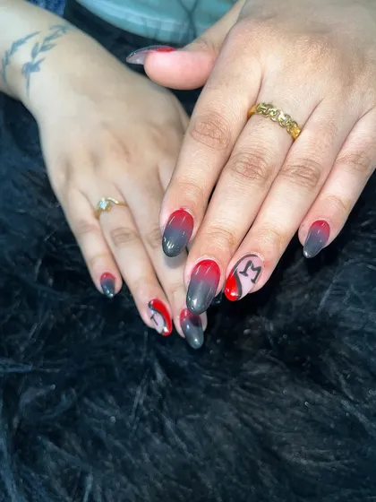 A red and black ombre set with custom initial art. This shows how you can personalize designs for your clients, which is a great way to build loyalty.
