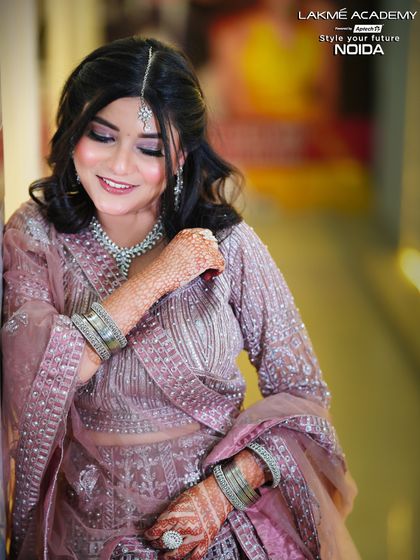 A happy and radiant engagement look. This student portfolio piece showcases a flawless base, soft eye makeup, and a smile that lights up the frame.