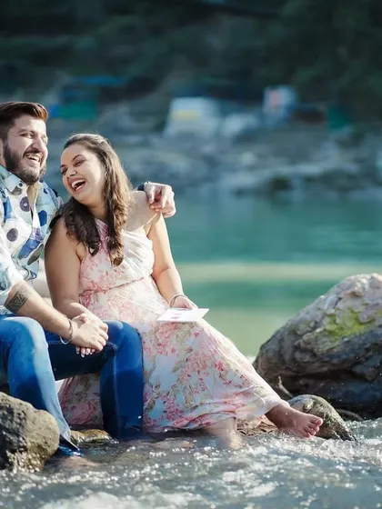 A joyful moment from the same riverside pre-wedding shoot, capturing the couple's laughter and connection.