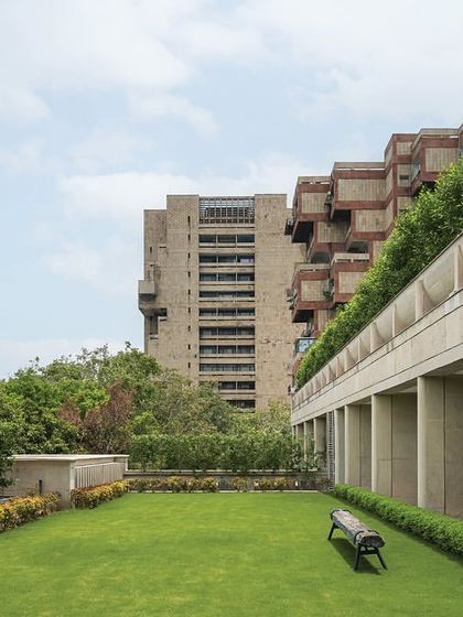 The landscaped terrace on the top floor of 'The Layered Office', accessible from the boardroom. This outdoor space provides a green retreat with views of the surrounding area, complete with a flagpole.