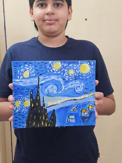 A student proudly displays his recreation of Van Gogh's 'Starry Night' on canvas, made during our 3-day artist workshop.