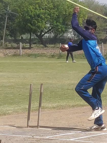 A spinner captured at the point of release. We focus on body mechanics to help our bowlers generate turn and drift.