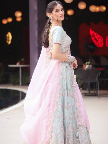 A full-length shot showing how the pastel lehenga and soft makeup come together for a truly ethereal engagement look. Perfect for a day or evening event.