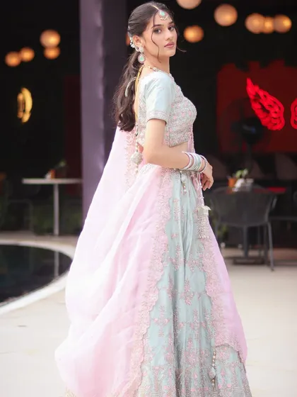 A full-length shot of the pastel pink and blue lehenga, a perfect inspiration for an engagement look.
