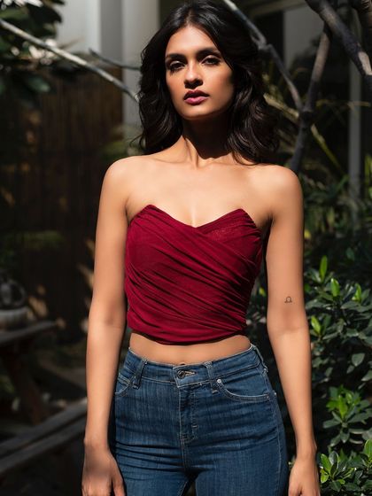 A bold and beautiful look for It Girl in a rich red top. The model's direct gaze is captivating.