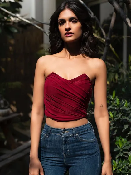 A bold and beautiful look for It Girl in a rich red top. The model's direct gaze is captivating.