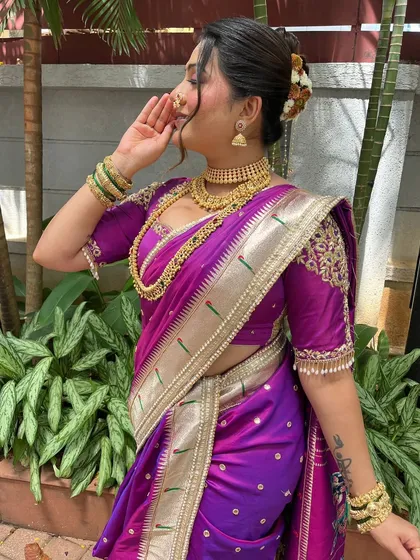 A side profile showing the beautiful hair bun adorned with flowers. This is a classic way to accessorize a traditional Maharashtrian hairstyle.