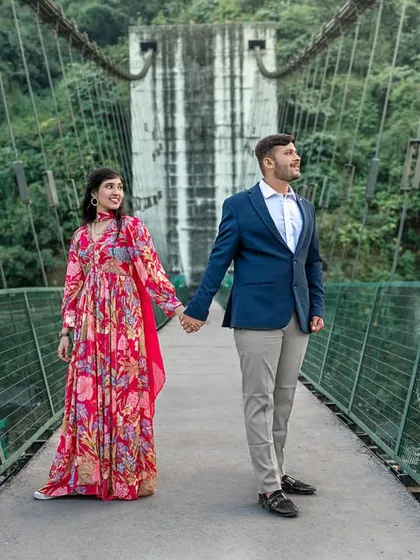 Hand in hand, they walk across the bridge towards their future. This shot captures the grandeur of the location and the beginning of their shared journey.