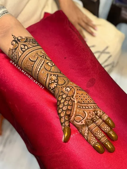 A full arm view of a peacock-themed design.