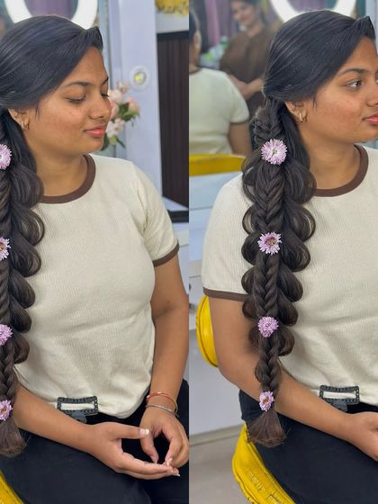 A still image of the beautiful side-swept floral braid.
