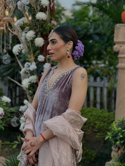 A side profile showing the floral hairstyle I chose for the wedding ceremony, which complemented the soft mauve tones of my self-designed velvet suit.