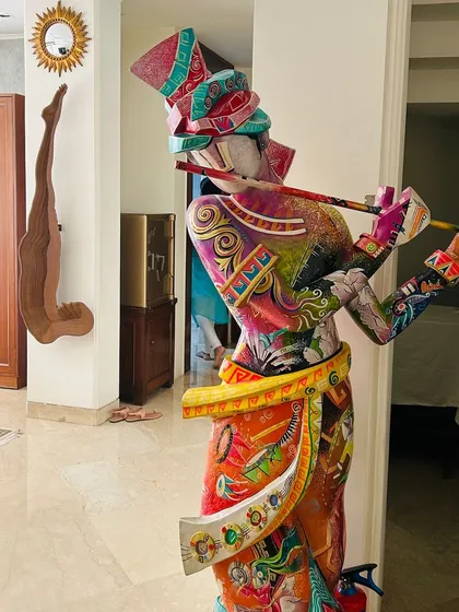 A vibrant, life-sized sculpture of a musician adds a dramatic and artistic flair to this hallway. We believe in integrating bold art pieces that transform a space and make a powerful statement.