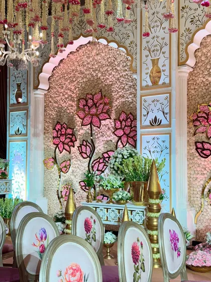 A closer look at the custom chairs and the detailed mandap backdrop. Every element is designed to complement the overall theme of regal elegance.