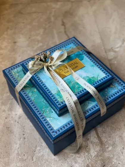 Our tiered festive boxes, elegantly tied with a custom ribbon. These are perfect for creating a grand impression for Diwali or wedding gifting.